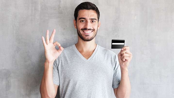 Benefits of Credit Card - Happy man holding credit card