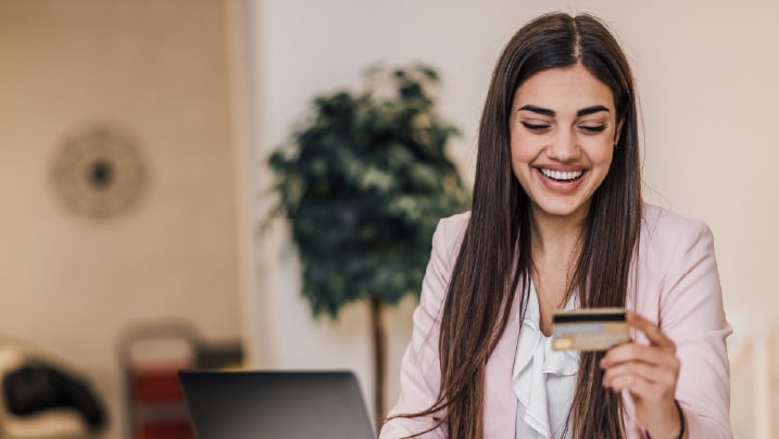 Happy working woman with credit card