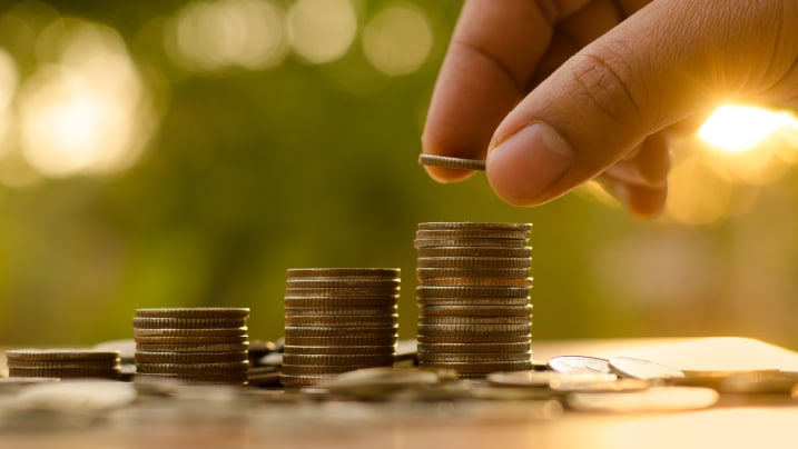  Male hand putting money coin stack