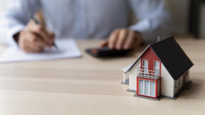 Estate agent giving house keys to client after signing agreement