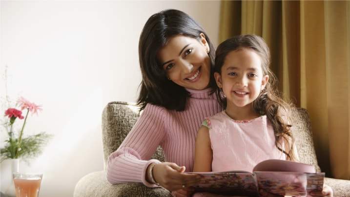 little girl siting on mother's lap