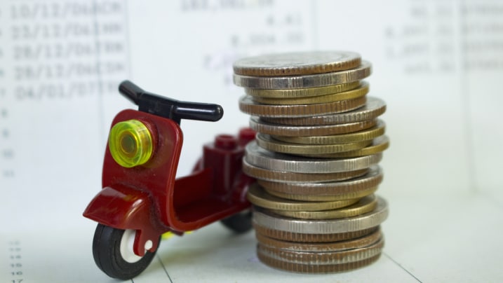 coins stacked together with a bike toy